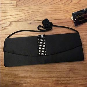 Clutch black new. Has a shoulder strap.